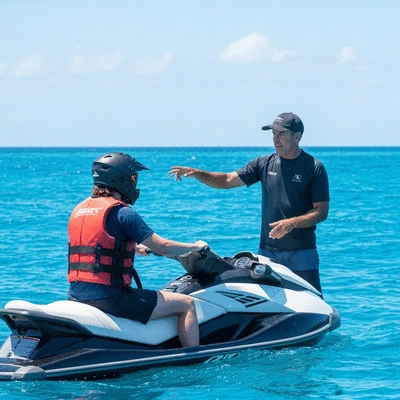 Person on a jet ski receiving instruction from an instructor on calm Australian waters, with safety gear visible