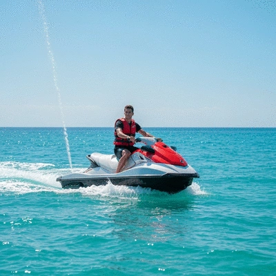 Person wearing a life jacket on a jet ski, clear blue water, sunny day, lifestyle photography