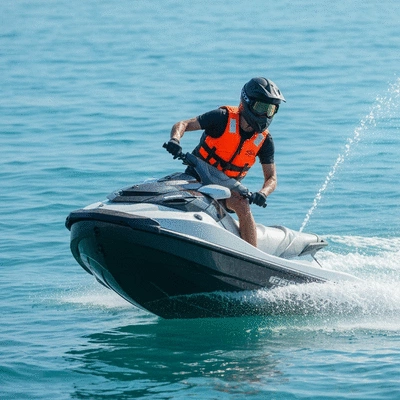 Jet ski rider wearing a life vest and helmet, on a jet ski in open water